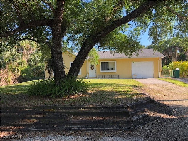 view of front facade featuring a garage, stucco siding, concrete driveway, and a front yard