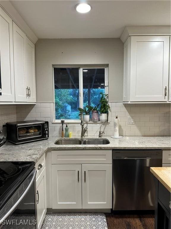 kitchen featuring a sink, white cabinets, and stainless steel appliances