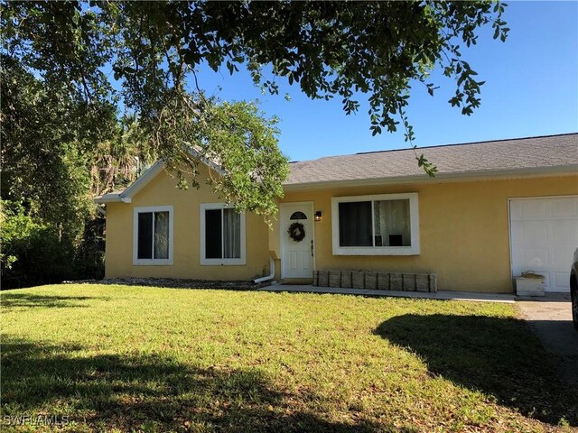 single story home with a front lawn and stucco siding