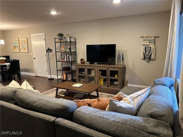 living area with baseboards, recessed lighting, and wood finished floors