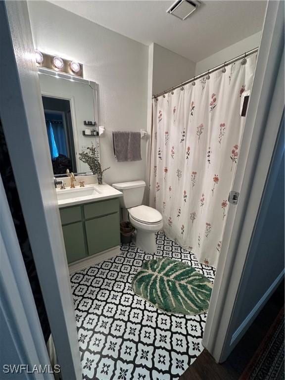 full bathroom with vanity, tile patterned flooring, a shower with curtain, toilet, and visible vents