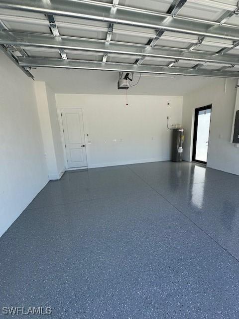 garage with water heater and a garage door opener