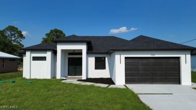 view of front of house featuring concrete driveway, stucco siding, a front yard, and a garage