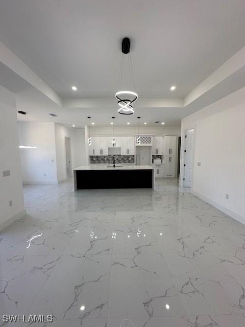 kitchen with light countertops, a raised ceiling, baseboards, white cabinetry, and recessed lighting