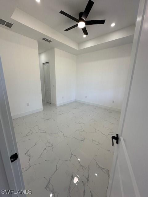 unfurnished room with recessed lighting, a raised ceiling, visible vents, baseboards, and ceiling fan
