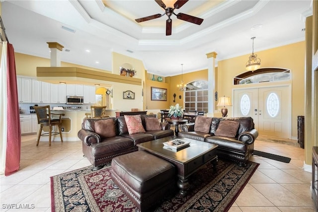 18510 Ellen Ave, Port Charlotte, FL 33948 - living room featuring crown molding, ceiling fan with notable chandelier, light tile patterned flooring, and visible vents