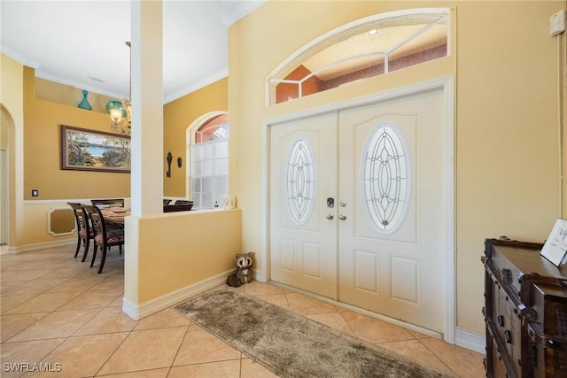 18510 Ellen Ave, Port Charlotte, FL 33948 - entrance foyer with arched walkways, light tile patterned floors, baseboards, and ornamental molding