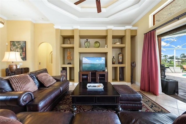 18510 Ellen Ave, Port Charlotte, FL 33948 - tiled living room with arched walkways, built in shelves, a ceiling fan, and crown molding