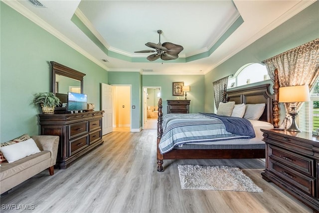18510 Ellen Ave, Port Charlotte, FL 33948 - bedroom with baseboards, a tray ceiling, ornamental molding, and wood finished floors