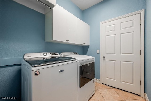 18510 Ellen Ave, Port Charlotte, FL 33948 - laundry area featuring cabinet space, light tile patterned floors, washing machine and clothes dryer, and baseboards