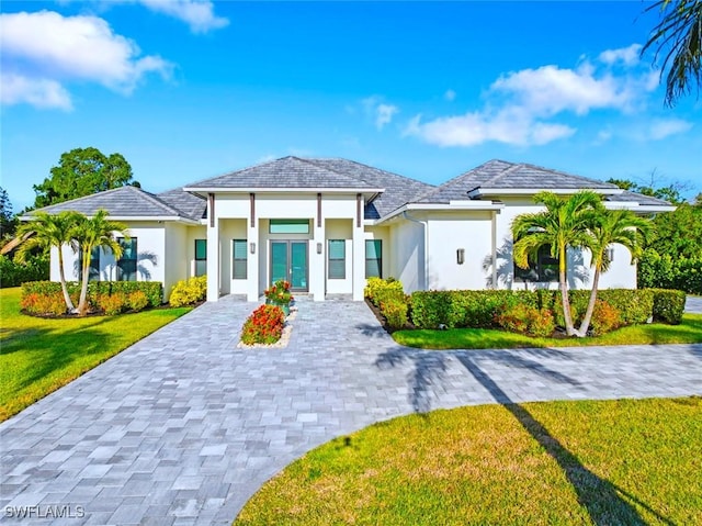 9974 Winterview Dr, Naples, FL 34109 - view of front facade with decorative driveway, stucco siding, and a front lawn