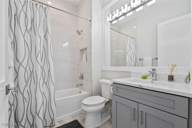 9974 Winterview Dr, Naples, FL 34109 - bathroom featuring vanity, wood finished floors, shower / tub combo with curtain, and toilet