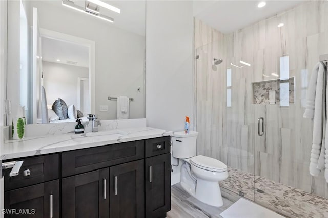 9974 Winterview Dr, Naples, FL 34109 - full bathroom featuring vanity, a marble finish shower, and toilet