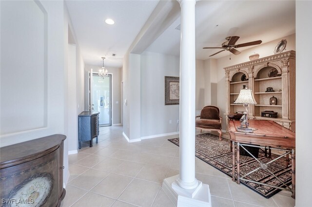 4660 Winged Foot Ct Unit 102, Naples, FL 34112 - corridor featuring decorative columns, baseboards, and light tile patterned floors