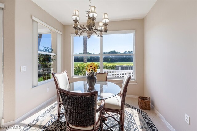 4660 Winged Foot Ct Unit 102, Naples, FL 34112 - tiled dining area featuring baseboards and a notable chandelier
