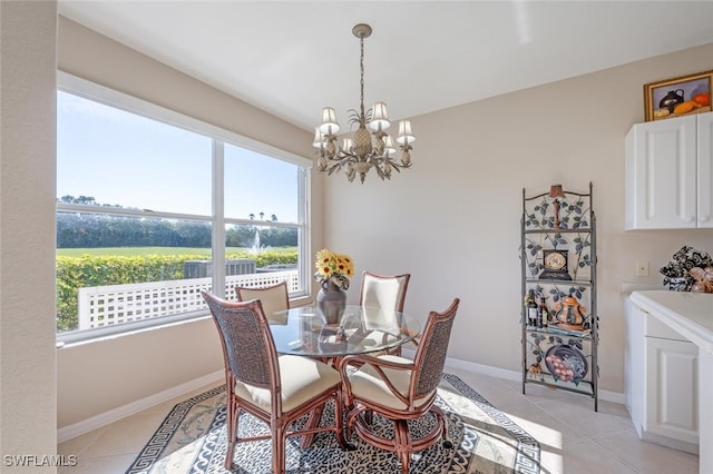 4660 Winged Foot Ct Unit 102, Naples, FL 34112 - dining area with a chandelier, light tile patterned floors, and baseboards
