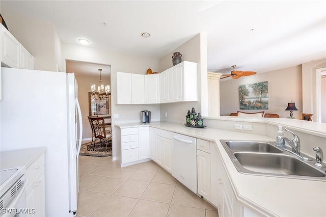 4660 Winged Foot Ct Unit 102, Naples, FL 34112 - kitchen featuring white appliances, white cabinetry, a sink, and light tile patterned flooring