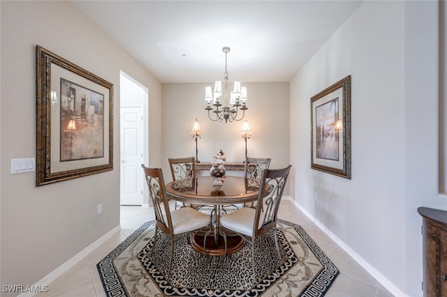 4660 Winged Foot Ct Unit 102, Naples, FL 34112 - dining area with light tile patterned floors, a notable chandelier, and baseboards