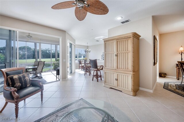 4660 Winged Foot Ct Unit 102, Naples, FL 34112 - living area with ceiling fan, baseboards, visible vents, and light tile patterned floors