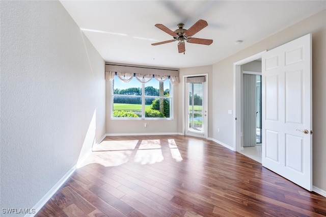 4660 Winged Foot Ct Unit 102, Naples, FL 34112 - spare room featuring ceiling fan, wood finished floors, and baseboards