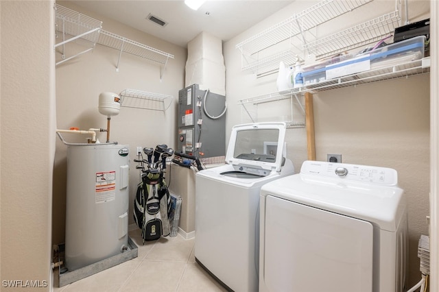 4660 Winged Foot Ct Unit 102, Naples, FL 34112 - washroom with laundry area, visible vents, water heater, washer and dryer, and tile patterned floors