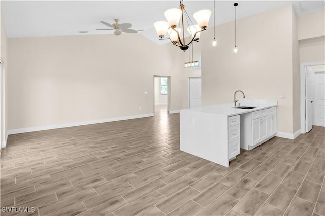 4911 Bywood St, Lehigh Acres, FL 33971 - kitchen with a sink, open floor plan, high vaulted ceiling, light wood-type flooring, and light countertops