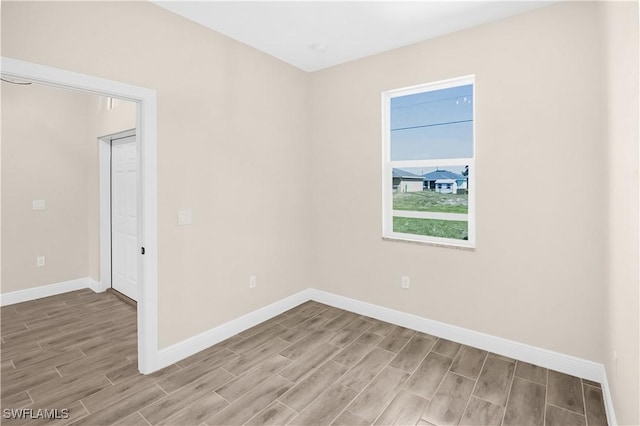 4911 Bywood St, Lehigh Acres, FL 33971 - spare room with light wood-style floors and baseboards