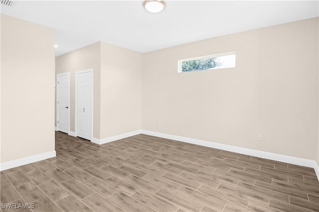 4911 Bywood St, Lehigh Acres, FL 33971 - empty room featuring baseboards and wood finished floors