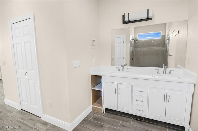 4911 Bywood St, Lehigh Acres, FL 33971 - bathroom featuring double vanity, baseboards, tiled shower, and wood tiled floors