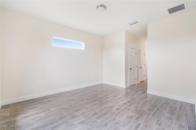 4909 Berryman St, Lehigh Acres, FL 33971 - spare room with light wood finished floors, baseboards, and visible vents