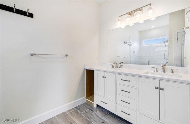 4909 Berryman St, Lehigh Acres, FL 33971 - bathroom featuring baseboards, an enclosed shower, a sink, and double vanity
