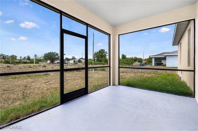 4909 Berryman St, Lehigh Acres, FL 33971 - unfurnished sunroom featuring finished concrete flooring