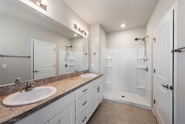 8813 Swell Brooks Ct, North Fort Myers, FL 33917 - bathroom featuring tiled shower, double vanity, tile patterned flooring, and recessed lighting