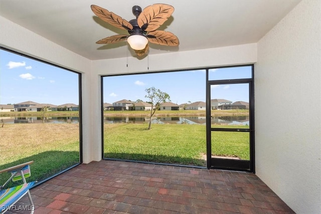 8813 Swell Brooks Ct, North Fort Myers, FL 33917 - unfurnished sunroom featuring a water view, a ceiling fan, and a residential view