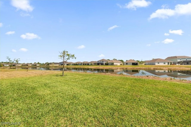 8813 Swell Brooks Ct, North Fort Myers, FL 33917 - view of green lawn featuring a water view and a residential view