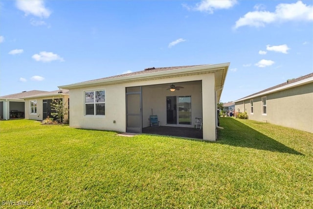 8813 Swell Brooks Ct, North Fort Myers, FL 33917 - back of property featuring a yard, stucco siding, and ceiling fan