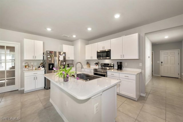 8813 Swell Brooks Ct, North Fort Myers, FL 33917 - kitchen featuring appliances with stainless steel finishes, white cabinets, light tile patterned floors, and recessed lighting