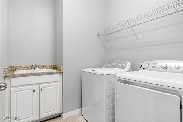 19874 Beverly Park Rd, Estero, FL 33928 - clothes washing area featuring a sink, baseboards, and washer and clothes dryer