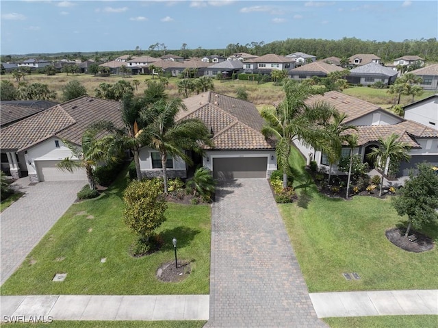 19874 Beverly Park Rd, Estero, FL 33928 - view of front of property with an attached garage, driveway, a residential view, and a tile roof