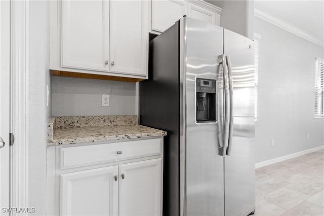 19874 Beverly Park Rd, Estero, FL 33928 - kitchen with stainless steel refrigerator with ice dispenser, crown molding, light stone countertops, baseboards, and white cabinetry