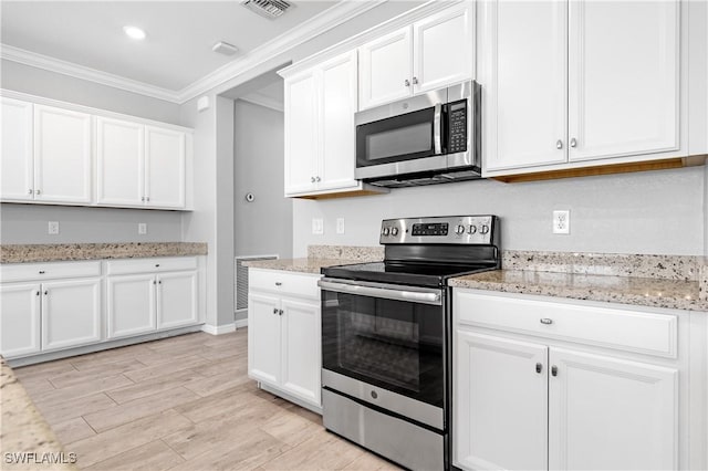 19874 Beverly Park Rd, Estero, FL 33928 - kitchen featuring crown molding, white cabinets, light wood-style floors, stainless steel appliances, and visible vents