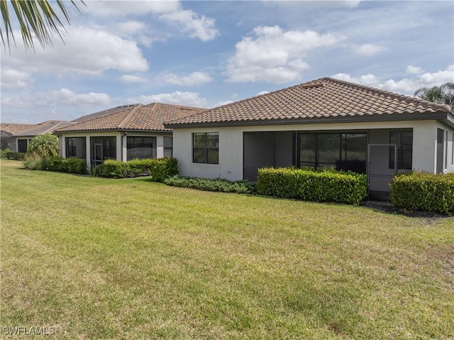 19874 Beverly Park Rd, Estero, FL 33928 - back of house featuring a lawn, stucco siding, and a tile roof