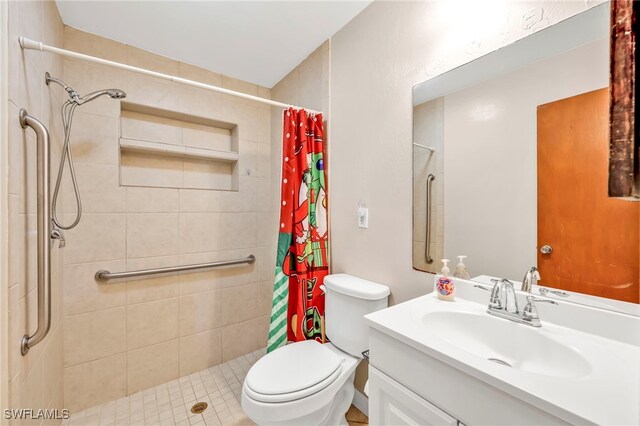 bathroom with toilet, a shower stall, and vanity