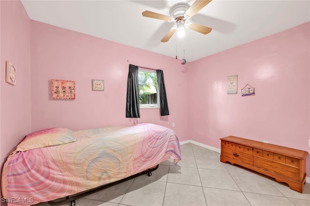 bedroom featuring light tile patterned floors, baseboards, and ceiling fan