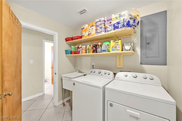 laundry area featuring visible vents, light tile patterned floors, separate washer and dryer, electric panel, and laundry area