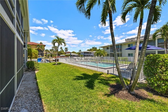 view of yard with fence and a community pool