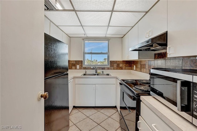 kitchen with a sink, light countertops, white cabinetry, under cabinet range hood, and black appliances