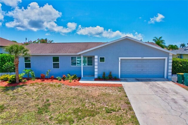 1357 Merrimac Ave, Marco Island, FL 34145 - ranch-style home with driveway, stucco siding, a garage, and a front yard
