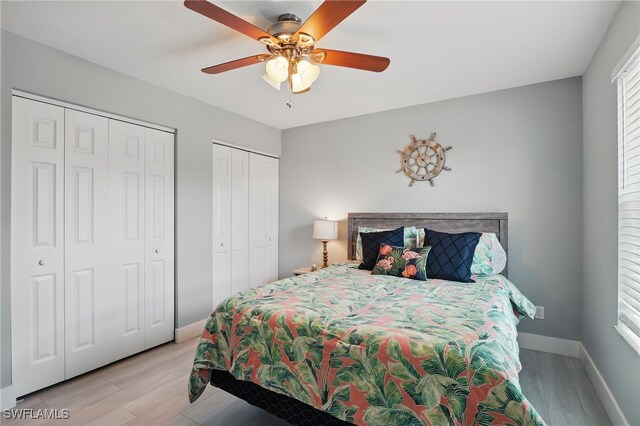 1357 Merrimac Ave, Marco Island, FL 34145 - bedroom with two closets, light wood-style flooring, baseboards, and a ceiling fan