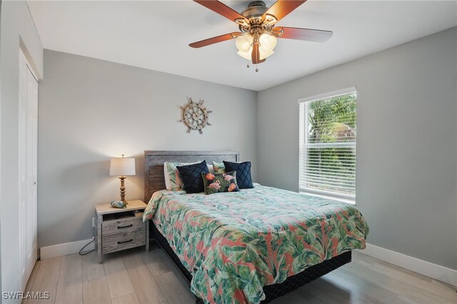 1357 Merrimac Ave, Marco Island, FL 34145 - bedroom with a closet, light wood-style floors, baseboards, and a ceiling fan